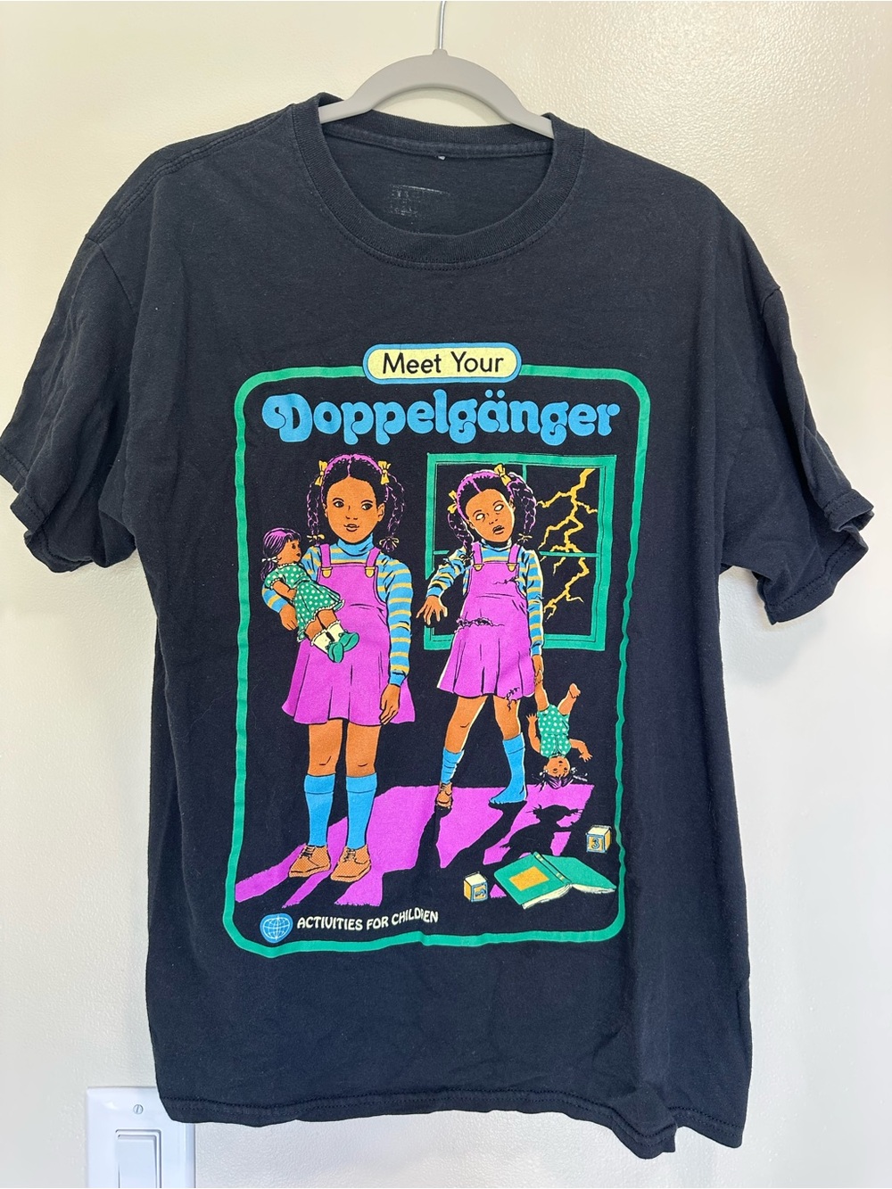 “Meet Your Doppelgänger” Black Graphic Tee with Purple & Teal Retro Doll Graphic